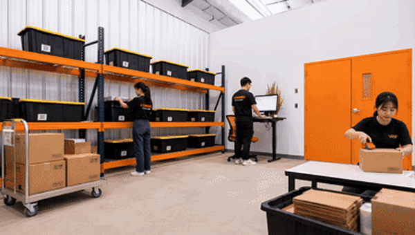 Team packing orders in a WorkHub Flex warehouse suite